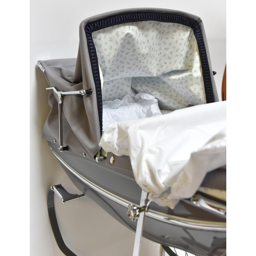 223 - A Silver Cross Doll's Pram. A very substantially built modern issue of this classic pram with gloss ... 