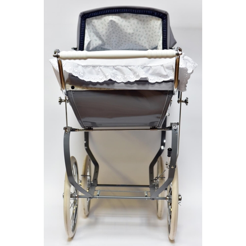 223 - A Silver Cross Doll's Pram. A very substantially built modern issue of this classic pram with gloss ... 