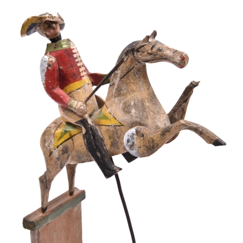 245 - A rare 19th Century wooden kinetic Toy. A mounted soldier with the horse in a prancing position, mou... 