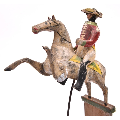 245 - A rare 19th Century wooden kinetic Toy. A mounted soldier with the horse in a prancing position, mou... 