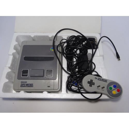 244 - A Super Nintendo games console. An early 1990s console with one controller, instructions and 2x game... 