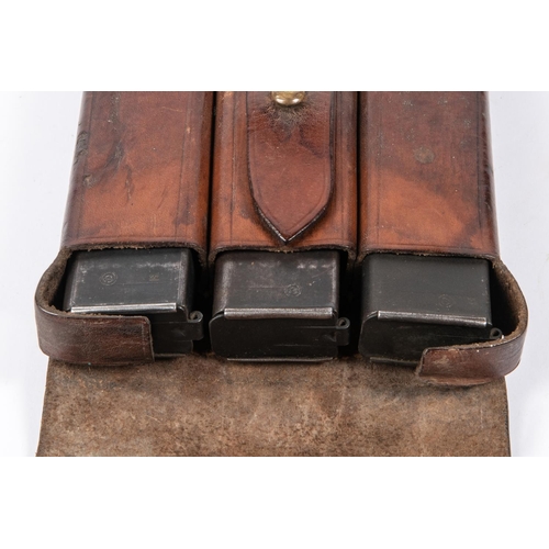 125 - A 3 pocket leather magazine pouch, possibly for MP34, contains 3 magazines. GC £40-45