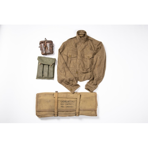 128 - A WWII cover for an Oerlikon gun, a 1949 pattern BD blouse; a pair of WW1 German field glasses (AF);... 