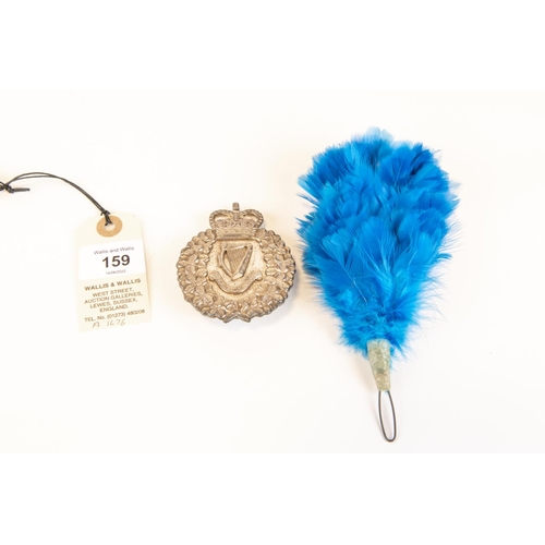 159 - A post 1953 London Irish Rifles piper's silver plated Caubeen badge; and companion blue feather hack... 