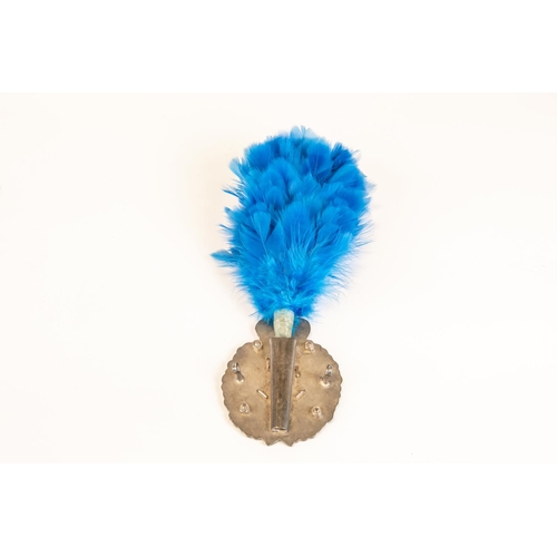 159 - A post 1953 London Irish Rifles piper's silver plated Caubeen badge; and companion blue feather hack... 