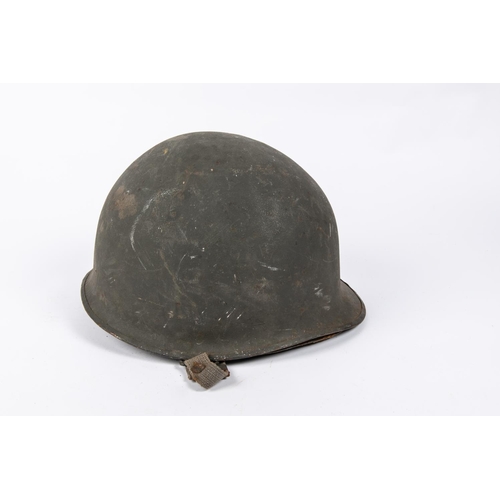 175 - A WWII US Steel helmet, complete with lining and original combat finish. GC £40-50