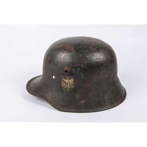 90 - The skull only of a German M1916 steel helmet, reissued during the Third Reich, with applied tri-col... 