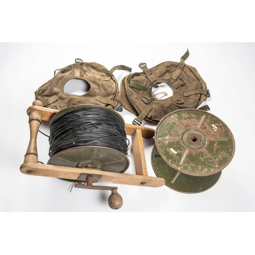 131 - A reel of DIO assault cable, with wooden laying frame; also another empty reel and 2 canvas reel cov... 