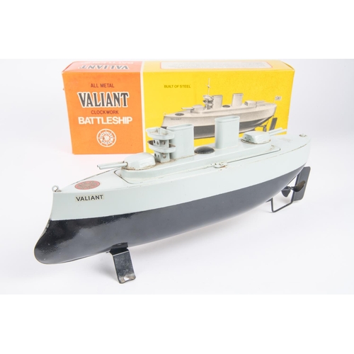 271 - A Sutcliffe Model Valiant clockwork tinplate Battleship. In black and blue-grey. Complete with mast,... 