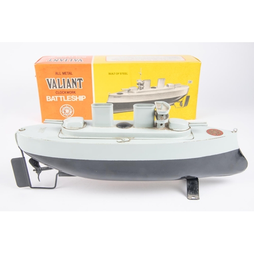 271 - A Sutcliffe Model Valiant clockwork tinplate Battleship. In black and blue-grey. Complete with mast,... 