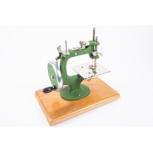 6 - A 1950s miniature Grain sewing machine. cast iron body finished in green, in orginal case. VGC. £20-... 