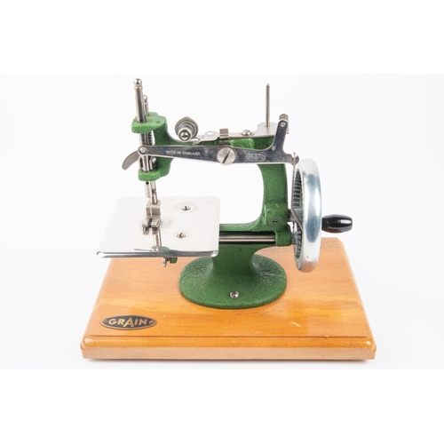 6 - A 1950s miniature Grain sewing machine. cast iron body finished in green, in orginal case. VGC. £20-... 