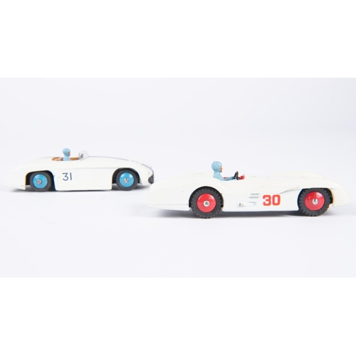 560 - 2 Dinky Toys. Cunningham C-5R Road Racer (133). In white with blue stripes, tan interior, blue wheel... 