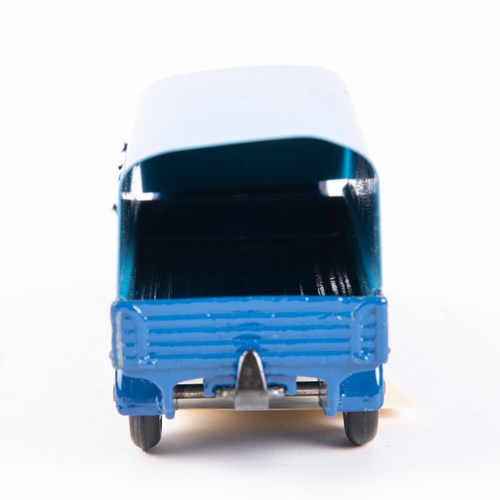 575 - A Dinky Toys Austin Covered Wagon (413). In dark blue with mid-blue tin-plate tilt and wheels. Boxed... 