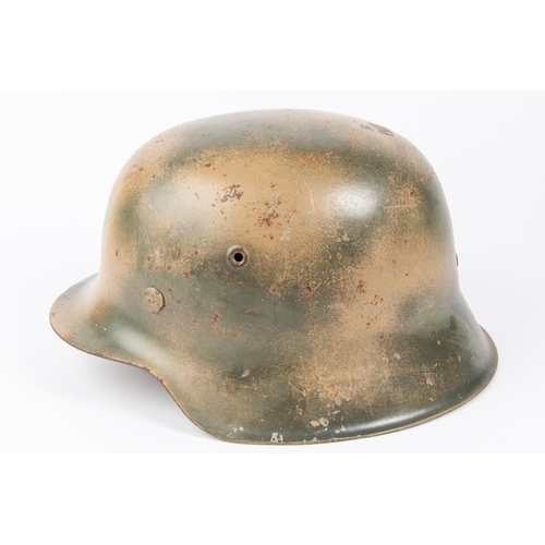 138 - A Third Reich M43 steel helmet, camouflaged finish, SS decal, lining possibly later replacement. GC ... 