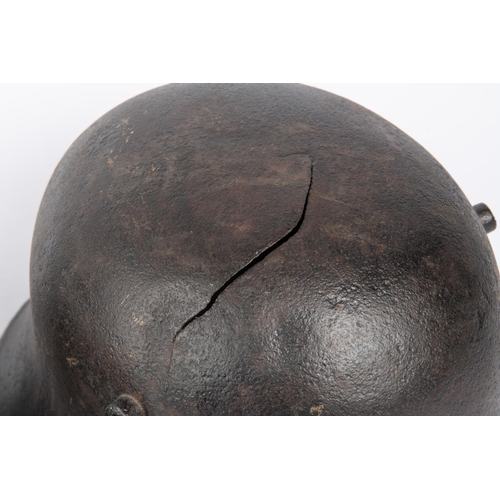 143 - 2 WWII German steel helmets, lining missing, black painted (1 with crack). GC £40-50