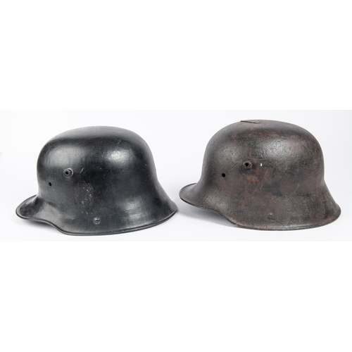 143 - 2 WWII German steel helmets, lining missing, black painted (1 with crack). GC £40-50