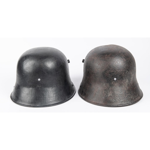 143 - 2 WWII German steel helmets, lining missing, black painted (1 with crack). GC £40-50