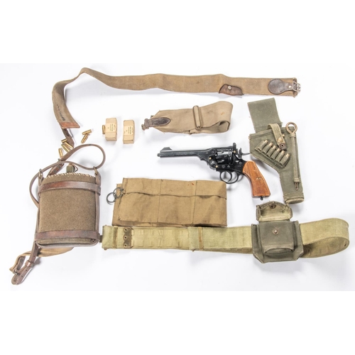 207 - A webbing holster containing a CO2 replica revolver, with cartridges; a webbing belt with cartridge ... 