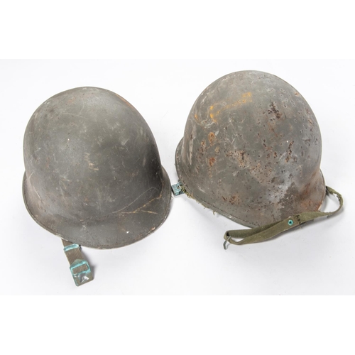 399 - 2 Korean War period US Army steel helmets, complete with linings and chin straps. £40-60