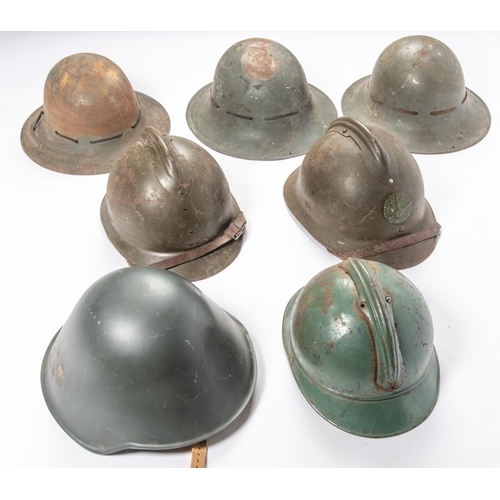 401 - A WWII French Adrian helmet, another (badge missing), another badge and lining missing; and 3 