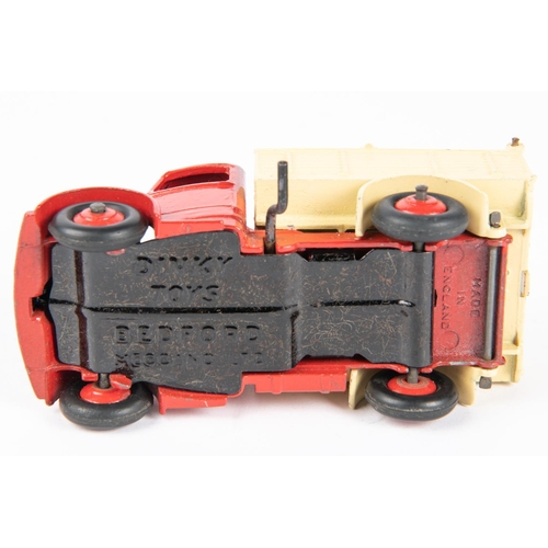 319 - Dinky Toys Bedford End Tipper (410). Red chassis cab with cream body and red wheels. Boxed, some wea... 