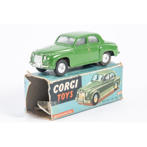 281 - Corgi Toys Rover 90 Saloon (204M). An early mechanical in dark green with a working friction powered... 