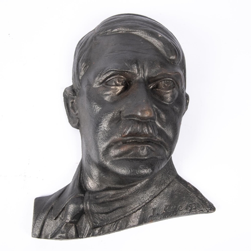 182 - A Third Reich cast metal bust of Hitler, front face in relief, 13