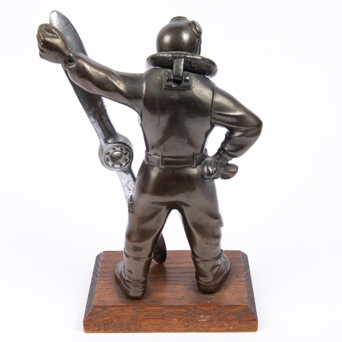 20 - A desk cigarette lighter, in the form of a bronzed figure of an airman in flying suit standing holdi... 