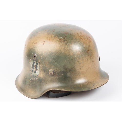 202 - A Third Reich M43 steel helmet, camouflaged finish, SS decal, lining possibly a later replacement. G... 