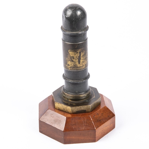 22 - A desk ornament made from the horn of a WWI sea mine, mounted on an octagonal wooden base, height 7