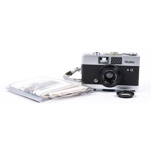 30 - A box of cameras and accessories. Including; an Olympus Trip 35 camera with instructions. A Rollei B... 