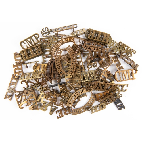 310 - Over 70 Corps brass shoulder titles, including approximately 20 pairs and many duplicates. Average G... 