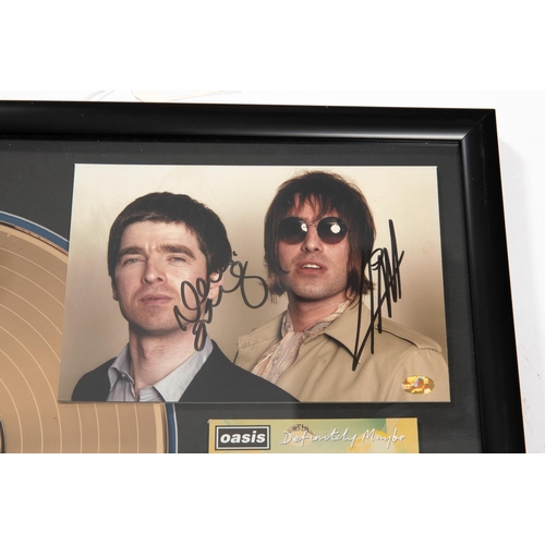 3 - A framed 'gold disc' of the band Oasis' album 'Definitely Maybe'. Framing includes; Gold vinyl LP, C... 