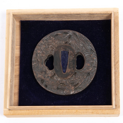 361 - A Japanese bronze tsuba, embossed on one side with leaves, flowers and dragon, and with spurious sig... 