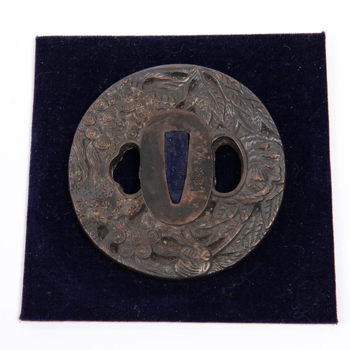 361 - A Japanese bronze tsuba, embossed on one side with leaves, flowers and dragon, and with spurious sig... 