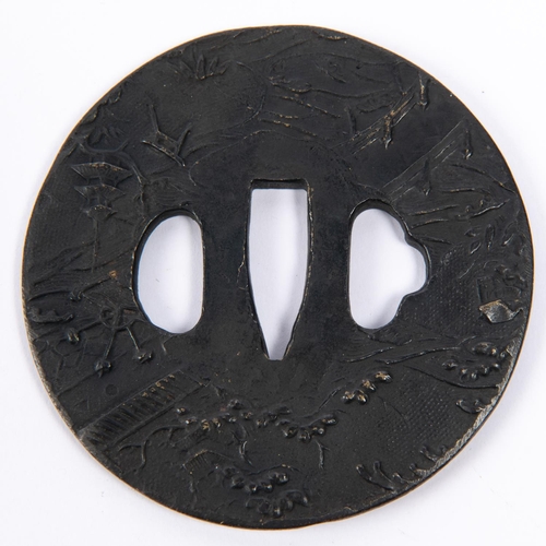 362 - A Japanese cast brass tsuba, blackened on  one side and embossed overall with rural scene. GC £50-60