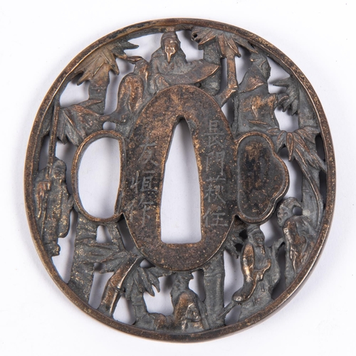 363 - A Japanese brass tsuba, pierced and embossed with figures and bamboo and with 2 line signature. GC £... 