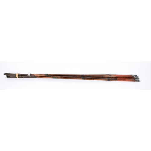 386 - A set of eight 18th century Indian arrows with flattened lozenge section heads, the dark bamboo shaf... 