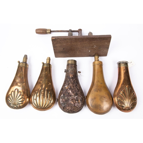 419 - An embossed copper powder flask 