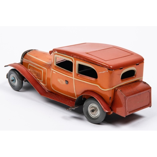 212 - A 1930's style Mettoy tinplate clockwork 2 door saloon car. In orangey red with cream line detailing... 