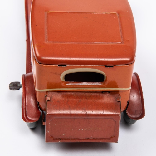 212 - A 1930's style Mettoy tinplate clockwork 2 door saloon car. In orangey red with cream line detailing... 