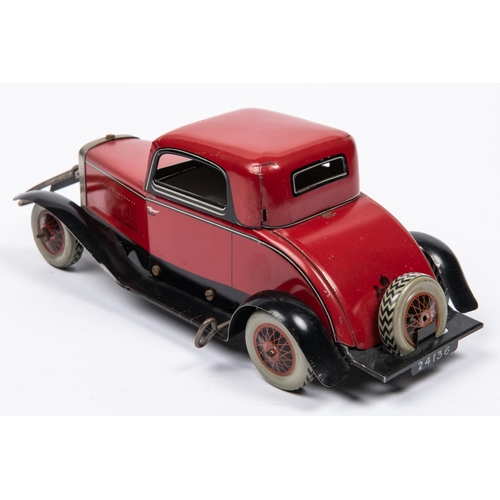 213 - A Chad Valley tinplate clockwork American style 2 seater saloon. Finished in red with black/silver l... 