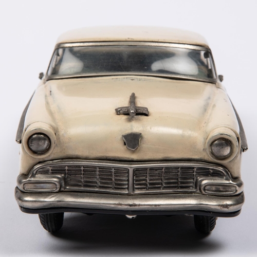 215 - A Japanese Asahi Toy Tinplate 2-door Sedan. A 1950s Ford Fairlane type car, in cream with red wheels... 