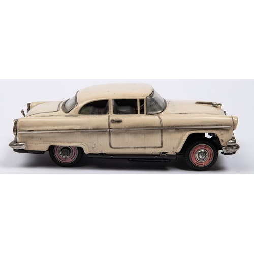 215 - A Japanese Asahi Toy Tinplate 2-door Sedan. A 1950s Ford Fairlane type car, in cream with red wheels... 