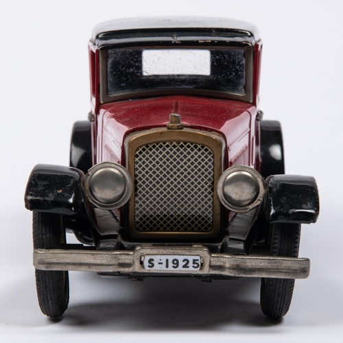 216 - A Japanese Tinplate 1930s American style Sedan. In red with black roof, sun visor, mudguards and run... 