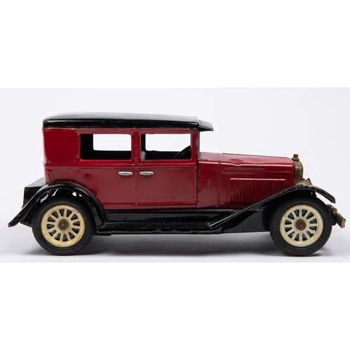 216 - A Japanese Tinplate 1930s American style Sedan. In red with black roof, sun visor, mudguards and run... 