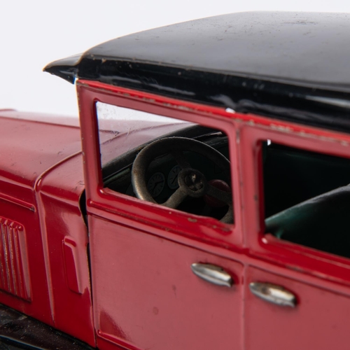 216 - A Japanese Tinplate 1930s American style Sedan. In red with black roof, sun visor, mudguards and run... 