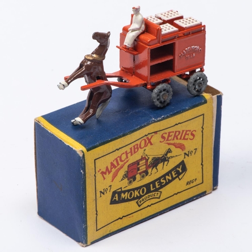 332 - A Matchbox Series No 7 Horse Drawn Milk Float. In pale orange, with brown horse, white driver, crate... 