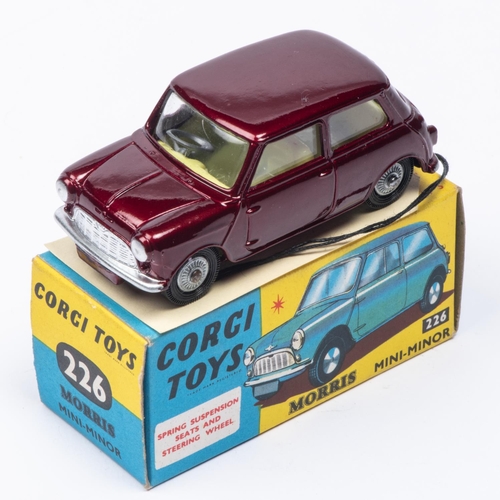 387 - A Corgi Toys Morris Mini-Minor (226). In metallic maroon with lemon interior and detailed cast wheel... 